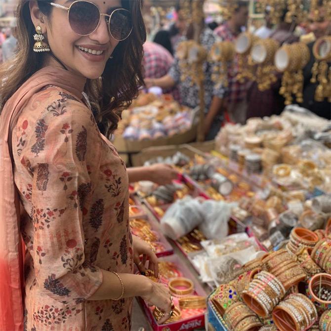 In photo: Nusrat Jahan is all smiles for the lenses as she plays with bangles while shopping at Charminar, Hyderabad.