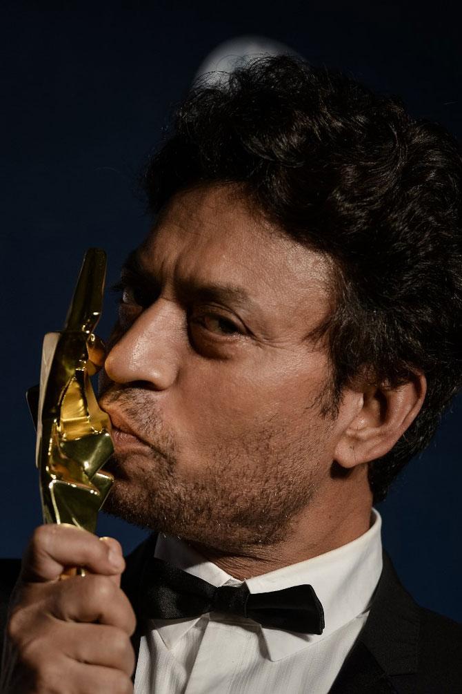 There's a moving anecdote about Irrfan being cast in Mira Nair's debut film Salaam Bombay! After Nair had cast Irrfan—while he was still studying at NSD—as one of the street children, he workshopped with the actual street children. But, when they did test shots, the malnourished children were much shorter, whereas Irrfan, over six feet, stood out oddly.
In picture: Best actor winner Irrfan Khan kisses his trophy during the Asian Film Awards in Macau on March 27, 2014.