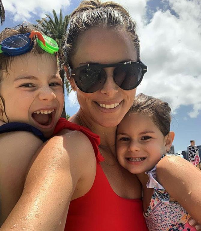 Candice Warner with her two children at the beach. She captioned it: Beach days with my babes. #babyissleeping #daddyisatwork