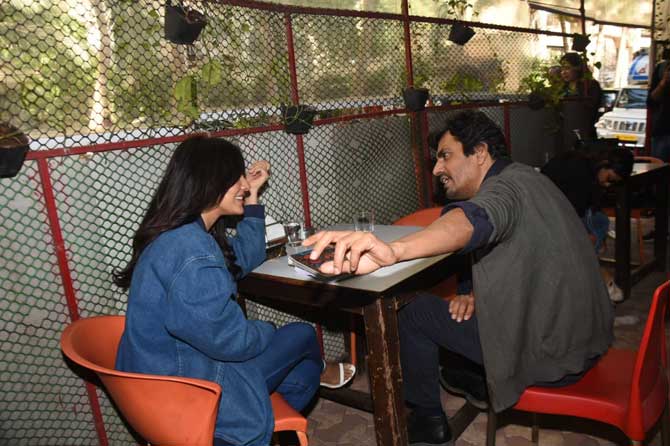 The duo was enjoying a script reading session of their new project. For the occasion, Neha opted for a white crop top, denim jacket and pants while Nawazuddin donned a grey jacket and denim.