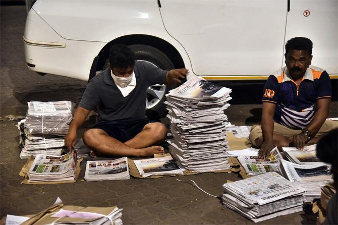 In photo: A vendor prepares to distribute newspapers as citizens wake up amidst coronavirus fear in Mumbai.