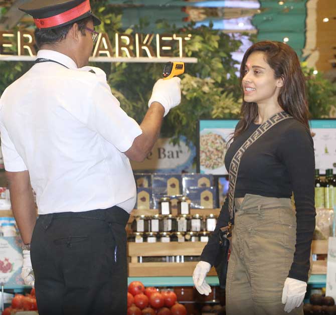 Like any upstanding Mumbaikar, Nushrat patiently waited for the guard to check her with a thermal scanner and then get in the food mall.