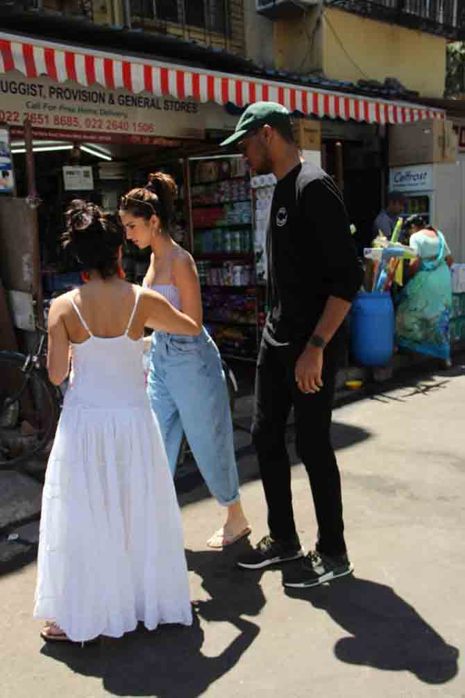 Tara Sutaria was spotted strolling the streets of Bandra, Mumbai, with sister Pia Sutaria. The actress was seen wearing a striped crop top, paired with boyfriend pants during the outing. All pictures/Yogen Shah