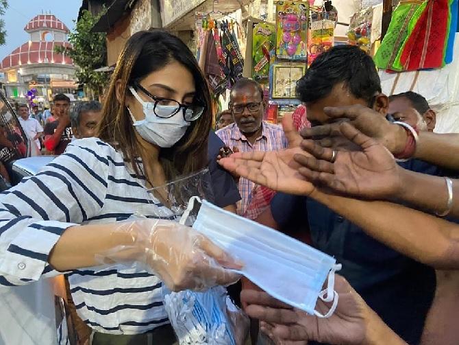 Nusrat was seen wearing a white and blue horizontal striped shirt with green pants. She left her hair open and also covered her mouth with a mask.