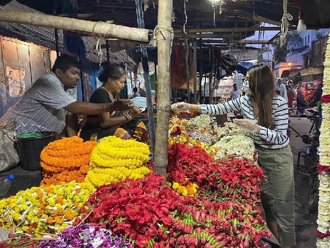 In picture: Nusrat Jahan hands over face masks to a few flower vendors