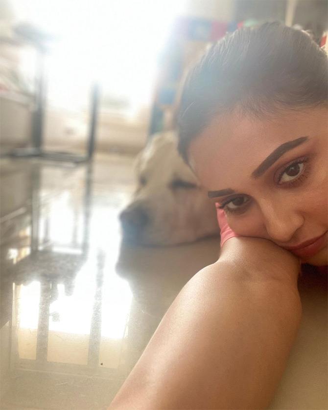 In photo: Mimi Chakraborty poses for a selfie with her pet dog Max. 