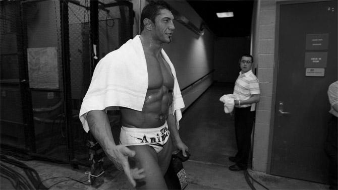 WWE superstar Batista making his way to the ring. Batista began acting in movies and retired from wrestling in 2019. He is a 6-time WWE world champion