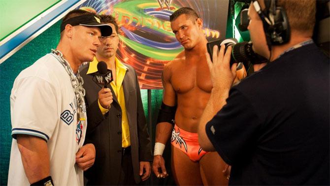 WWE superstar John Cena caught candidly cutting a promo as Randy Orton looks on. Cena and Orton had one of the most epic rivalries in WWE history.