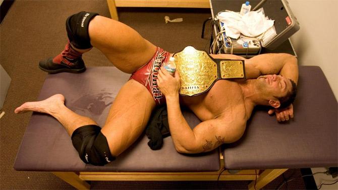 WWE superstar Batista lying down in the dressing room after he won the WWE World Heavyweight Championship against Triple H at WrestleMania 21.