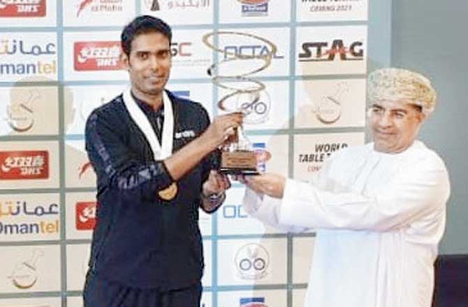 Achanta Sharath Kamal receives the Oman Open trophy yesterday