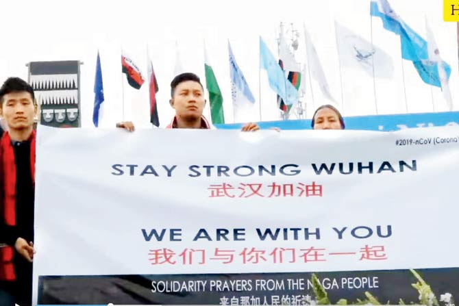 (Top) Ngachonmi Chamroy; (above) people hold up a poster at Lui Ngai Ni festival, where Chamroy’s song was performed  last month