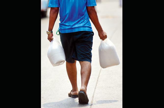 A man carries home large packages of supplies at Kanjurmarg on Wednesday. Pic/Sameer Markande