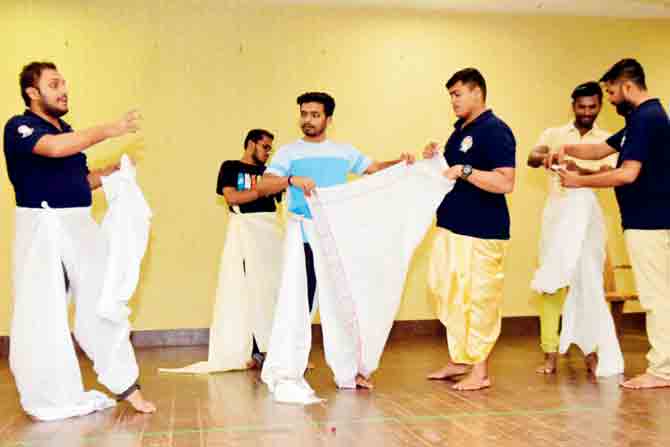 Nauwari saree and dhotar draping session at a pre-Gudhi Padwa workshop by Swami Vivekanand Pratishthan being held at Sharada Mandir High School, Gamdevi last week. PIC/BIPIN KOKATE