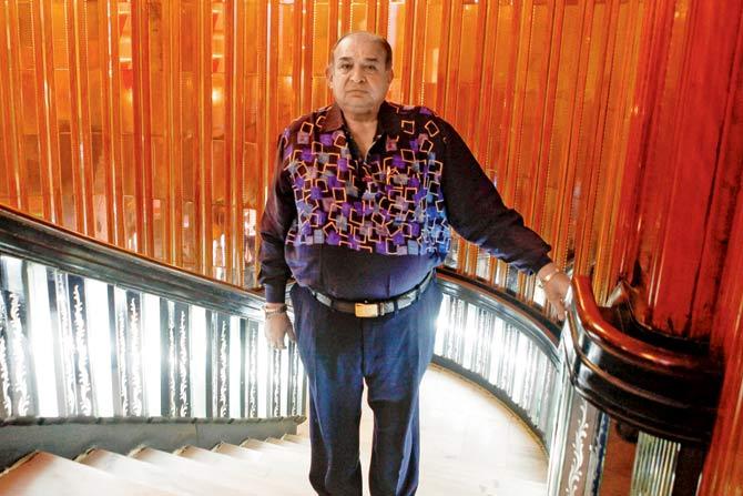 Manoj Desai, executive director of Maratha Mandir theatre, in the Belgian glass-panelled interior of the 1958-built cinema that creates history this year, screening Dilwale Dulhania Le Jayenge for 25 consecutive years since its release. The interiors are resplendent with the Art Deco ceiling and wall flourishes along the grand staircase. PICS/ASHISH RAJE