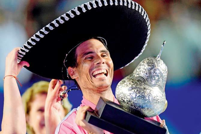 Rafel Nadal wears a sombrero while posing with the Mexico Open  trophy on Saturday. pic/AFP