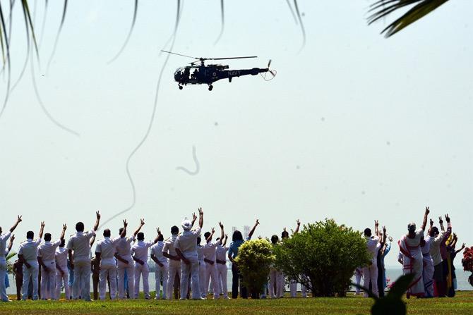 In photo: Indian Air Force helicopter showers flowers on the staff of Indian Navy's INHS Asvini Hospital in South Mumbai.