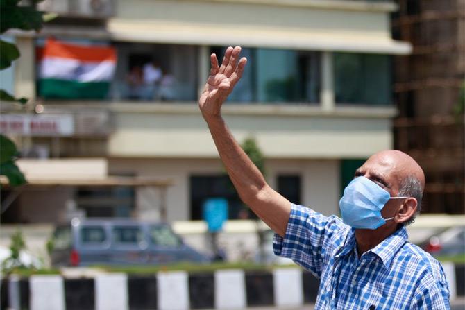 In photo: A senior citizen waves at the IAF aircraft at Marine Drive in South Mumbai.