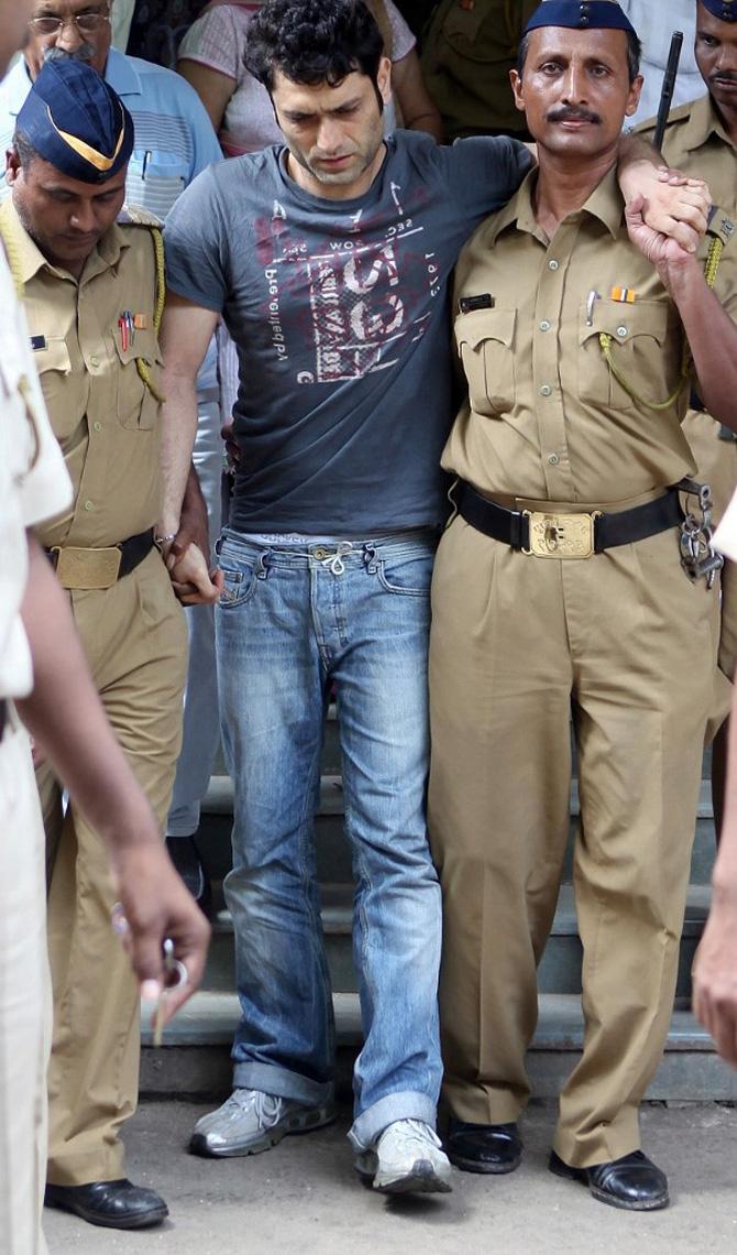 While things on the professional front were doing well for Shiney Ahuja, his personal life became messy when he was arrested on charges of raping, detaining and threatening his 19-year-old domestic help in June 2009. He was booked under Section 376 (rape), and Section 506 (threat to kill) of the IPC.
In picture: Shiney Ahuja is supported by policemen as he comes out of a city court in Mumbai on September 25, 2009. A fast track court directed the jail authorities to provide immediate medical relief to Ahuja, arrested for allegedly raping his maid, on his application seeking treatment. Shiney was seen crying and wincing in pain following a slipped disc problem and later had to be flanked outside in a semi-conscious state by constables as he was not able to walk.