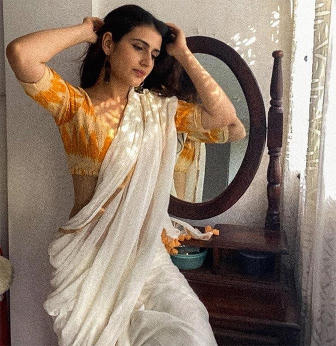 This photo is part of a photoshoot she did with a celebrated photographer through facetime. Fatima looked pretty in her white saree as she posed for the shot.