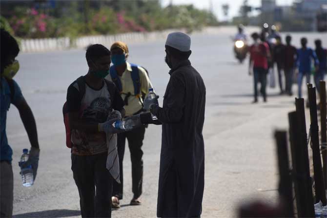 In picture: Local communities provide water to migrant workers in Thane