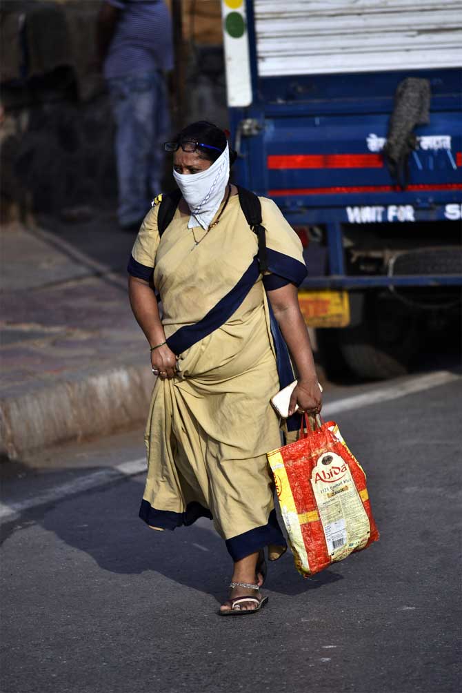 On Friday, as many as 1,576 new COVID-19 cases were detected in Maharashtra, taking the number of such patients in the state to 29,100, the health department said.
In picture: A police constable heads home after her duty at Dharavi.