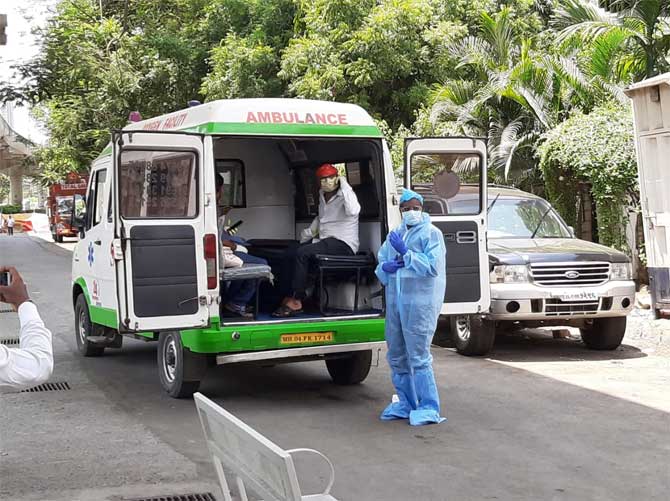 The total number of COVID-19 positive cases stands at 81,970 with 2,649 deaths while there are 51,401 active coronavirus cases. Health Ministry said that 27,920 people have been cured.
In picture: Health workers wait to take a Coronavirus patient to a quarantine facility outside Saidham Temple at Western Express Highway near Thakur Complex in Kandivali (East).