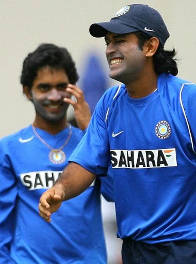 Kartickle your funny bone?: Indian cricketer Dinesh Kartik (L) watches team-mate Mahender Singh Dhoni (R) laugh during a practice session at the Beasejour stadium in Gros Islet, St Lucia 09 June 2006. The first of the four test match series between India and West Indies ended in a draw with the second test due to start on 10 June