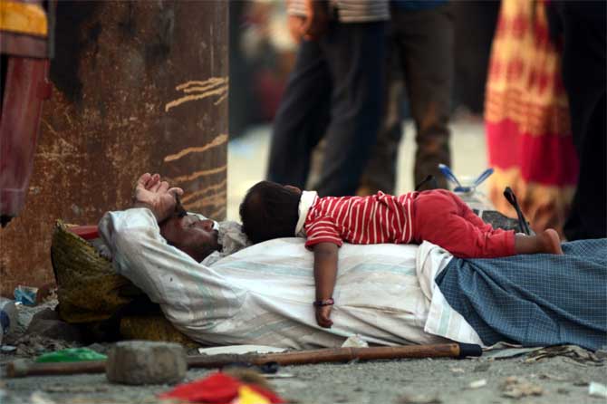 A 26-year-old woman from the Mahim fisherman colony was also among the new cases. Three other cases were reported from Dadar taking the total count in the area to 176 cases.
In picture: A child rest on its father as they wait for a MSRTC bus to take them to the Maharashtra-Madhya Pradesh border.