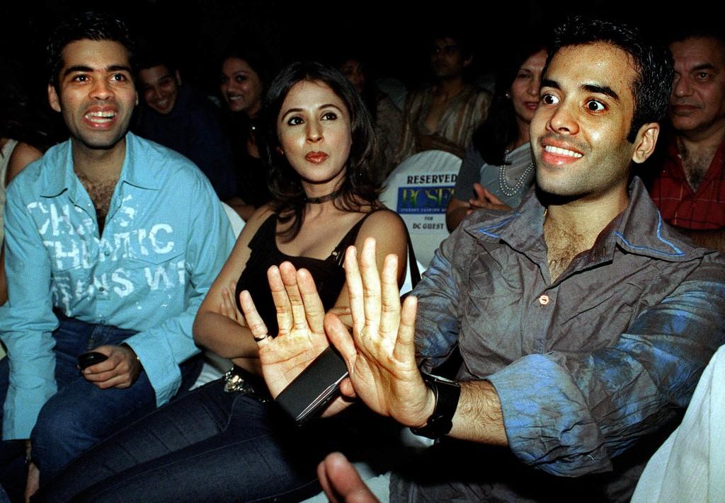 Tushar Kapoor gestures to a friend as actress Urmila Matondkar and filmmaker Karan Johar look on during designer Manish Malhotra's 'Just Chill' pret collection fashion show in Mumbai on May 3, 2003.