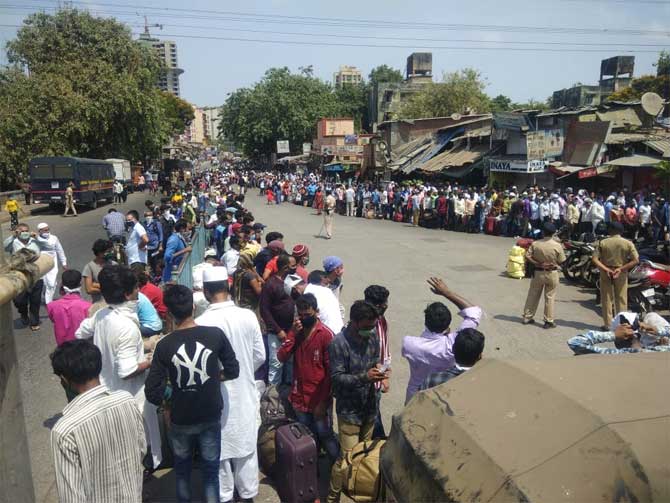 On Tuesday, a marginal drop was recorded in Mumbai's COVID-19 cases count with 1,002 new ones reported, even as Maharashtra recorded the highest number of single-day deaths at 97, with more than 2,000 fresh cases added to the state's toll.
In picture: Migrant workers queue up in Sion. 