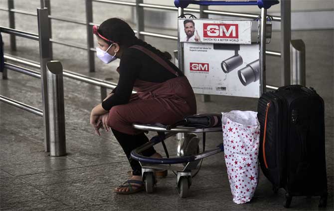 Maharashtra reported 97 coronavirus deaths -- highest in a day -- and 2,091 new patients, a health official said, adding that Mumbai alone accounted for 39 deaths.
In picture: A passenger waits for her flight at the T2 Terminal of the Chhatrapati Shivaji Maharaj International Airport. 
