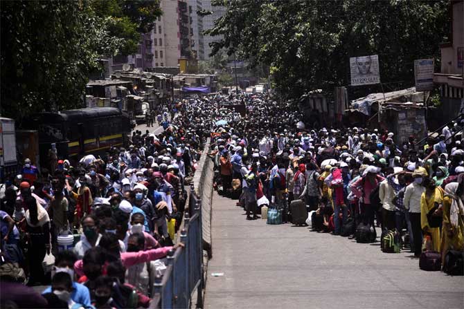 Civic officials also stated that there are 686 active containment zones in slum areas and chawls in Mumbai and 2,826 buildings have been sealed after residents tested positive. 
In picture: Migrant workers queue up as they wait for a bus in Dharavi.
