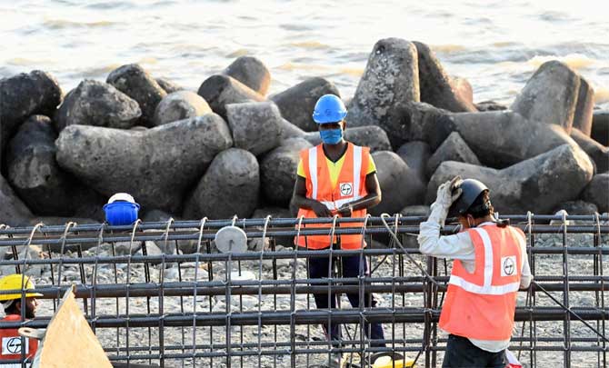 The new guidelines signed by Ajoy Mehta, chief secretary, mention that seven days institutional quarantine will be enough with the rest of the seven days at home. After the traveller is assessed by the receiving states, 14 days home quarantine may be permitted in special cases with the mandatory use of Arogya Setu app.
In picture: Labourers work on the Coastal Road project at Marine Drive.