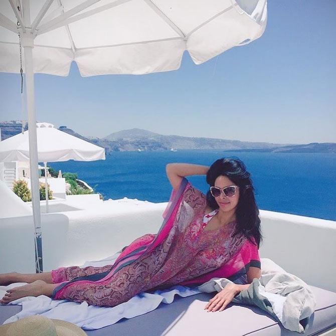 In this one, Mallika Sherawat was seen chilling by the sea, in her chiffon kaftan, posing for the camera. Do you know what's the highlight? The scenic beauty! She wrote, 