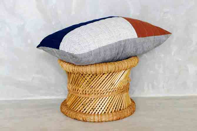 A quilted  cushion made from naturally-dyed,  handwoven cotton