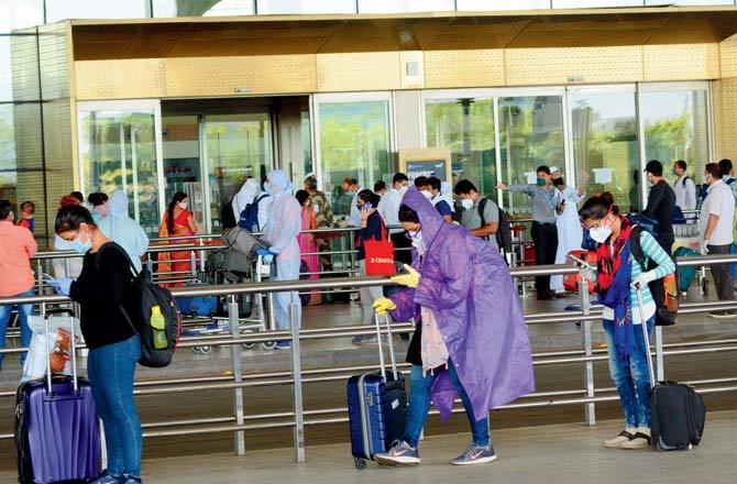 Passengers wait at the entrance of Chhatrapati Shivaji International Airport Terminal 2 on Monday. Pic/Satej Shinde