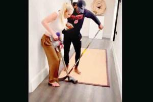 Lindsey Vonn plays hockey with a vacuum cleaner