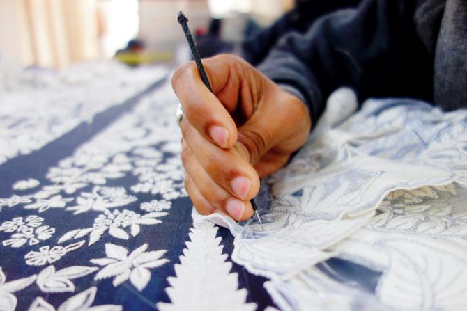 Rahul Mishra uses bursts of hand embroidery as a way to elevate the otherwise flat shapes, giving them a whimsical, three-dimensional appeal  