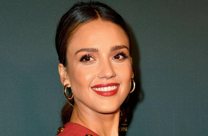Jessica Alba looks radiant with red lips. Pic/AFP