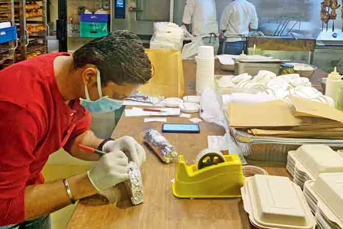 a staff member carefully seals an item