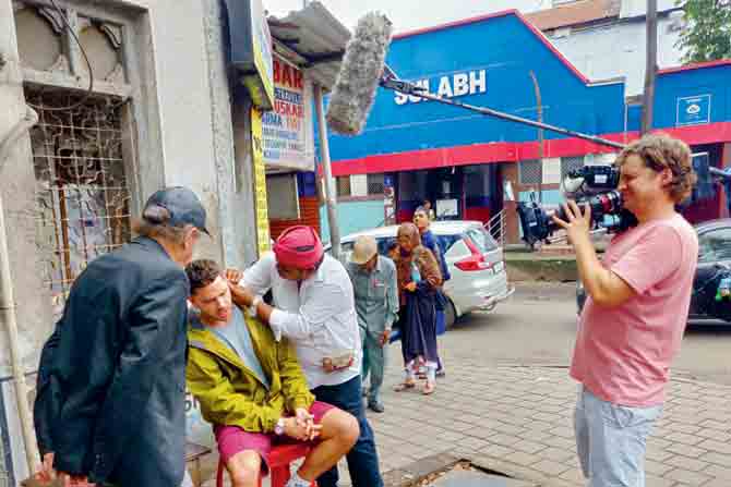 Adam Thomas is filmed getting his ears cleaned from a kaan-saaf wallah near Crawford Market