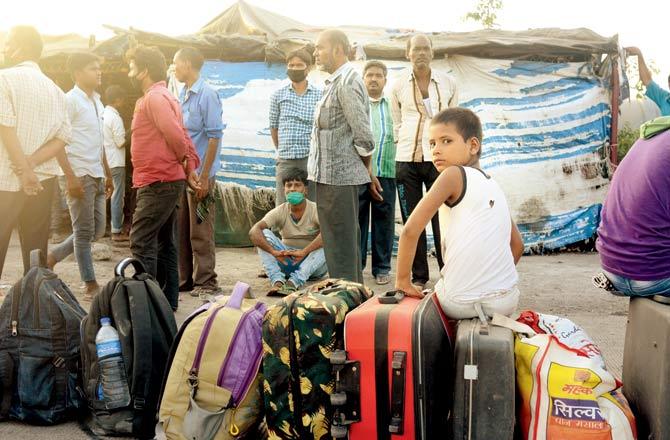 Migrants gather at various ST bus stops on the Mumbai-Nashik highway to board ST buses