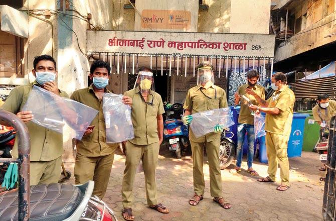 BMC workers wearing the face masks they received thanks to the effort
