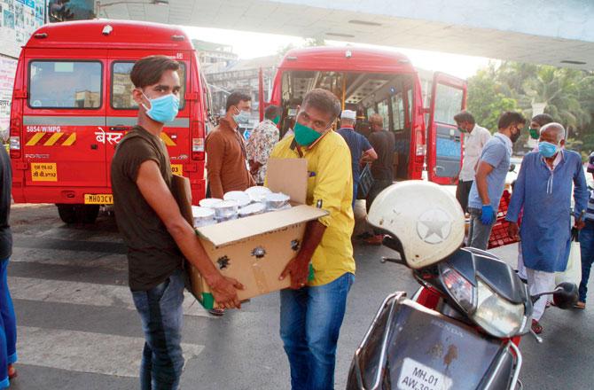 A file picture of BMC workers distributing food packets in Byculla. Pic/Ashish Raje