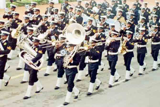 Kalyani (first place, first row from right) playing the sousaphone, an  instrument of the tuba family that coils around the body, at the Republic Day parade in 1999. The tuba can be spotted with the member next to him.