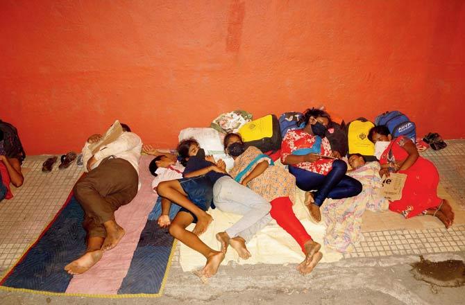 Migrants sleep on the footpath near Suncity ground