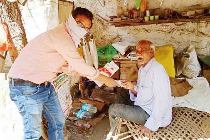 Kedare Jayram receives his pension from postal assistant Pradip Bhandwalkar