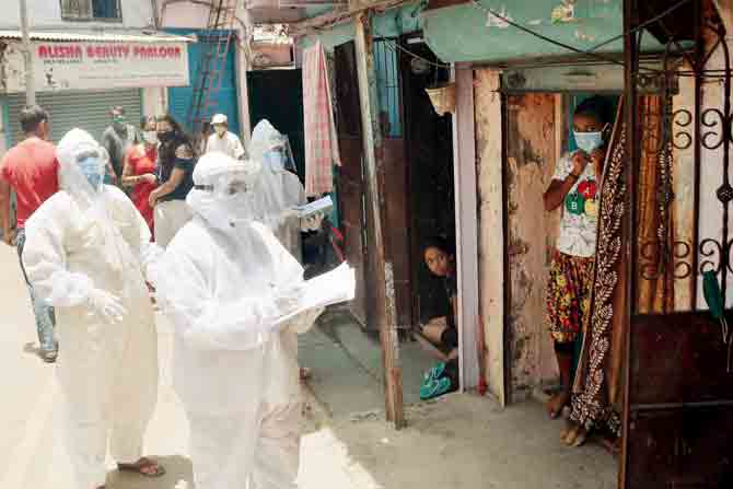 Civic doctors and health workers in PPE suits conducting a door-to-door thermal reading at Gavde Chawl on Andheri Kurla Road. PIC/sayyed sameer abedi