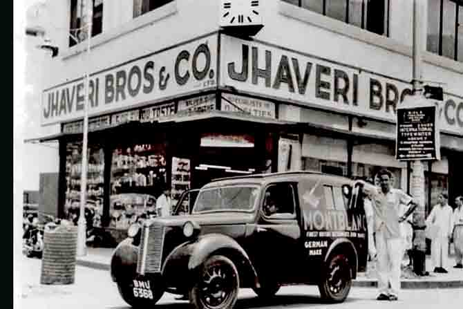 An early view of the Jhaveri Bros & Co. corner store at Metro House, with the Mont Blanc van parked in the foreground. 