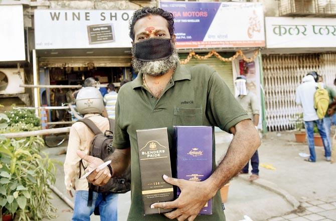A man with his liquor stock in Sion on Monday. Pic/Pradeep Dhivar